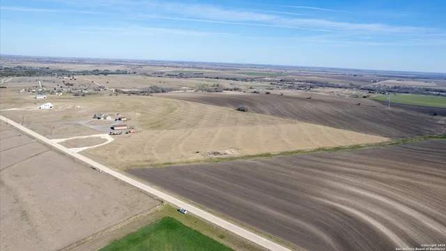 a view of a backyard with wooden fence