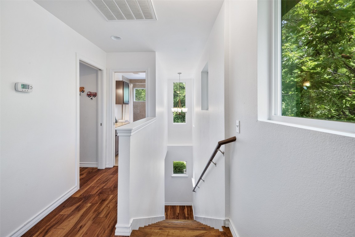 3407 Banton Road, Unit A Austin, TX 78722 - Photo 12 of 39 Stairs featuring healthy amount of natural light and wood finished floors