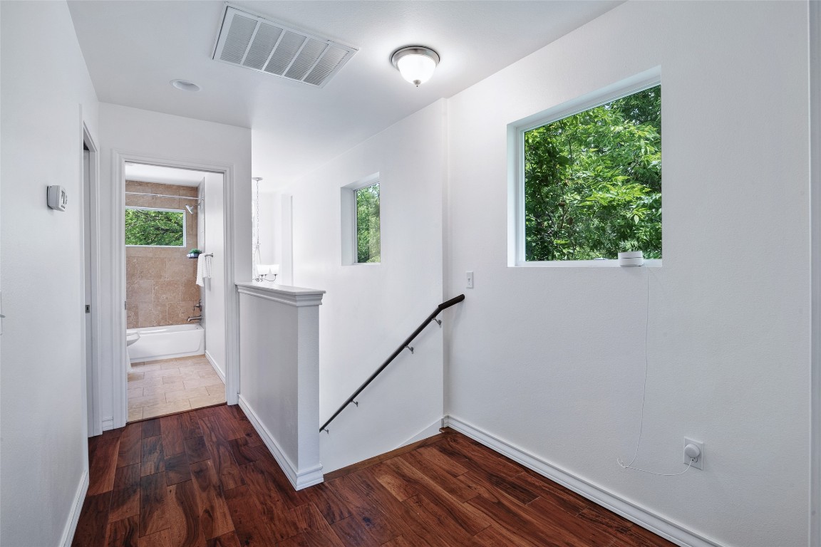 3407 Banton Road, Unit A Austin, TX 78722 - Photo 13 of 39 Corridor with an upstairs landing and dark wood-type flooring