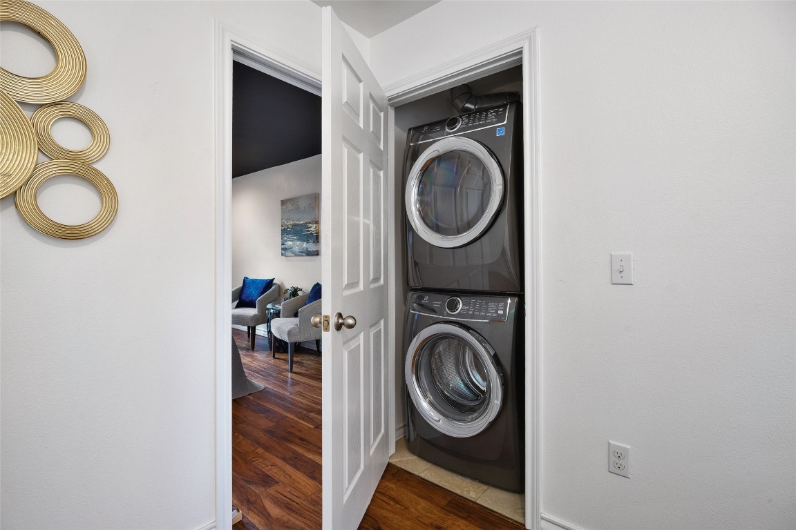 3407 Banton Road, Unit A Austin, TX 78722 - Photo 17 of 39 Washroom featuring stacked washing machine and dryer and dark wood-style floors