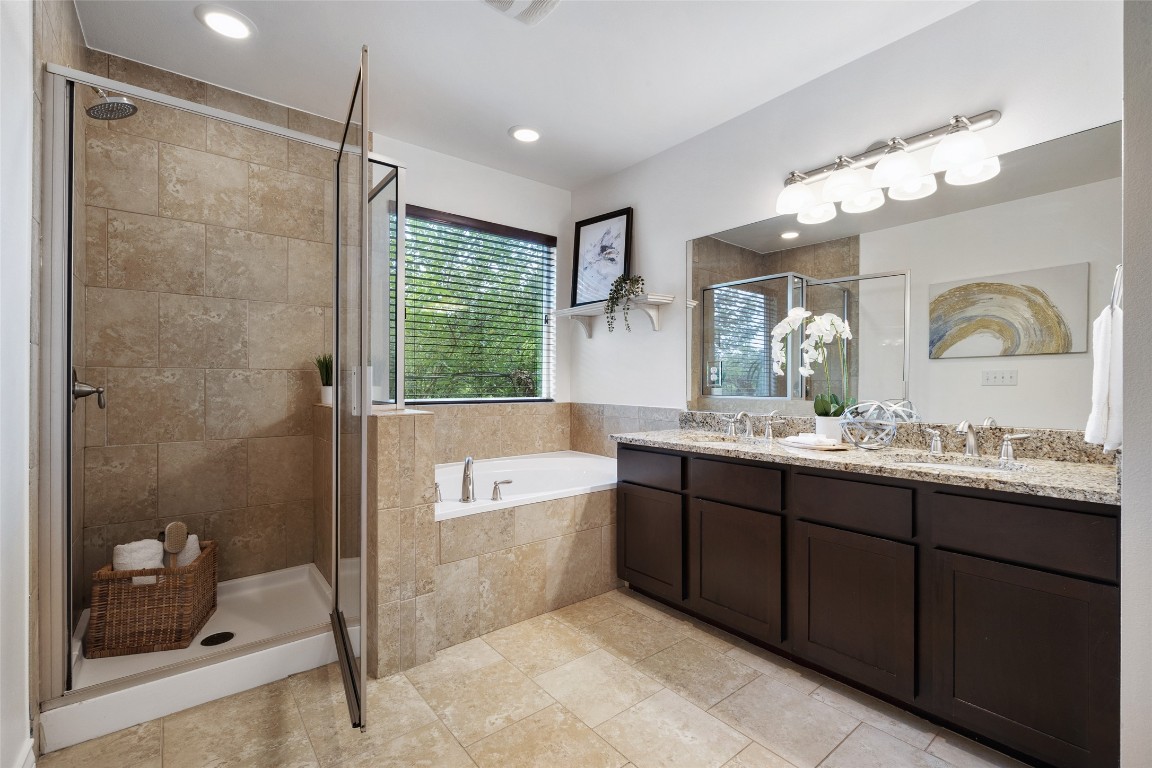 3407 Banton Road, Unit A Austin, TX 78722 - Photo 20 of 39 Bathroom with double vanity, a garden tub, and a stall shower