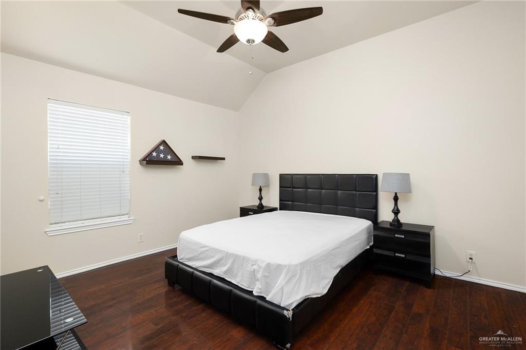 3400 San Angelo Street Mission, TX 78572 - Photo 11 of 12 a bedroom with a bed and wooden floor