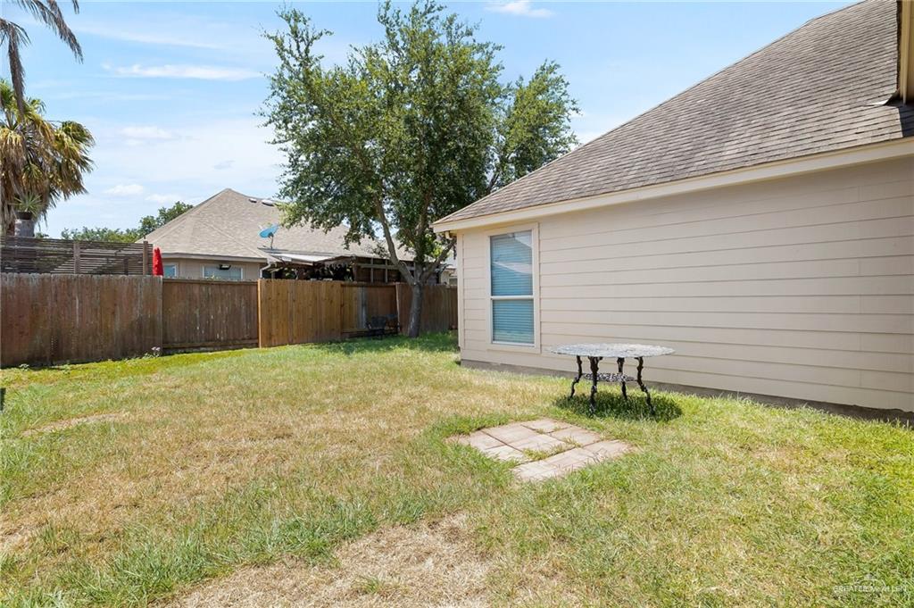 3400 San Angelo Street Mission, TX 78572 - Photo 12 of 12 a backyard of a house with yard and trampoline