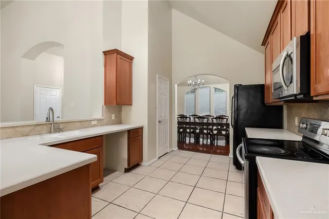 a kitchen with stainless steel appliances a sink stove and cabinets