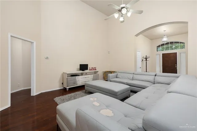 a living room with furniture and a wooden floor