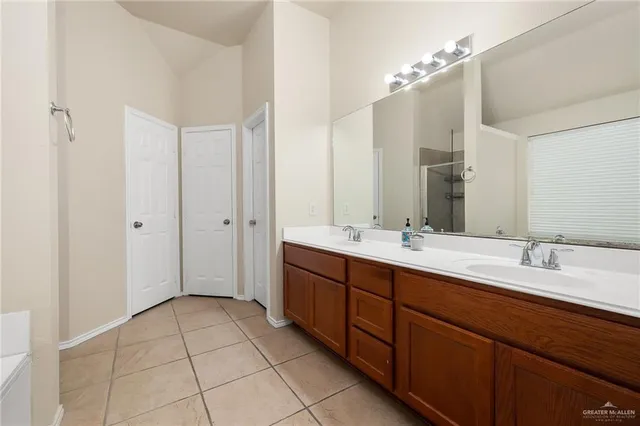 a spacious bathroom with a double vanity sink mirror and double