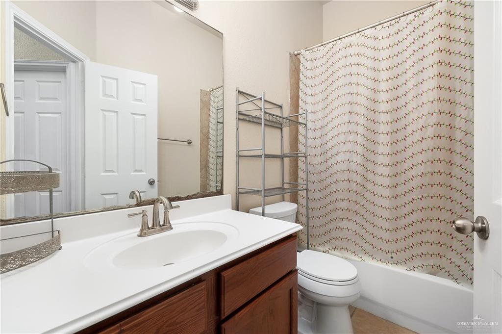 3400 San Angelo Street Mission, TX 78572 - Photo 10 of 12 a bathroom with a sink a toilet and shower