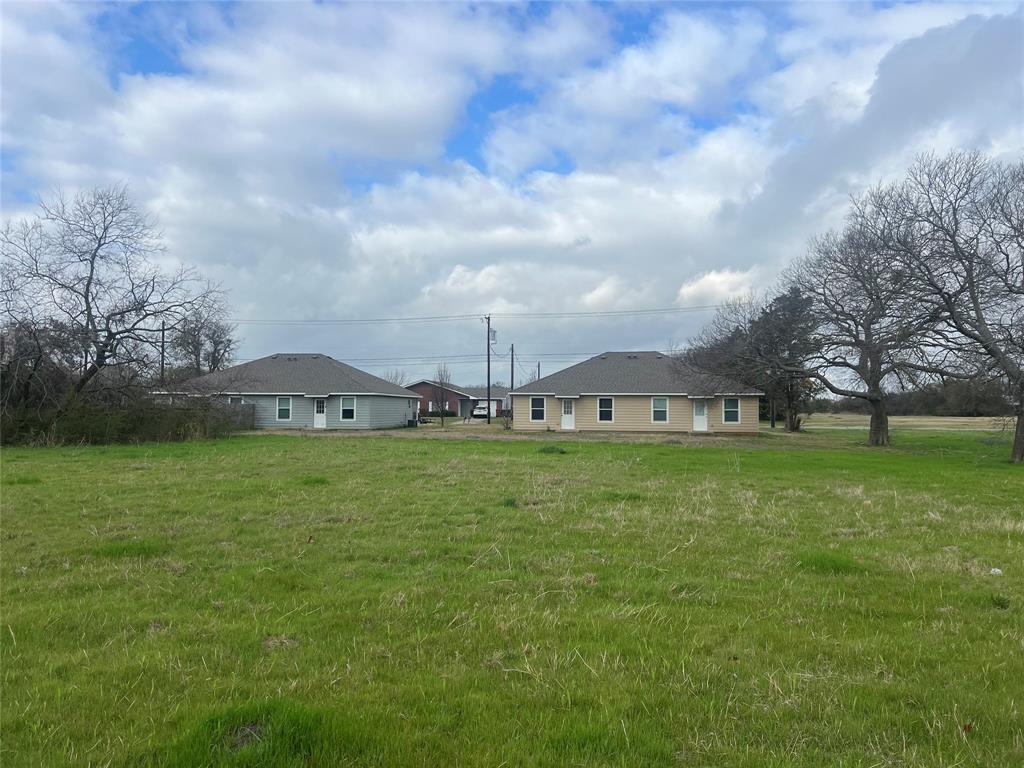 Tbd Albert Broadfoot Street Bonham, TX 75418 - Photo 7 of 7 a view of a house with a big yard and a large tree