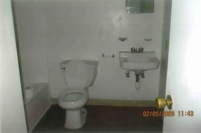 a bathroom with a toilet and a sink