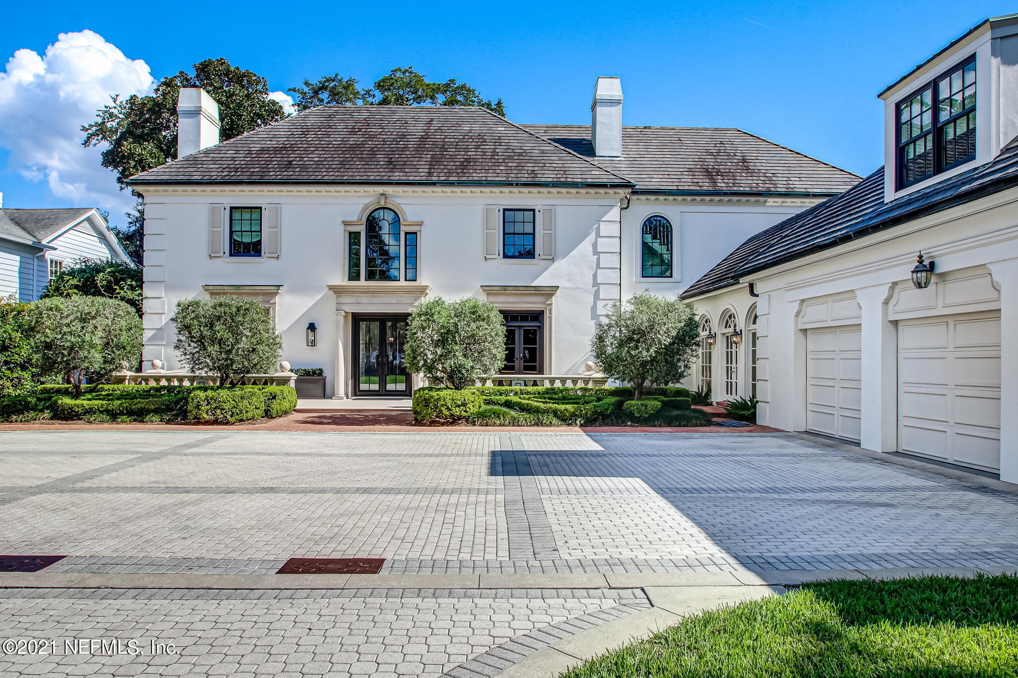 a front view of a house with a yard and a garage