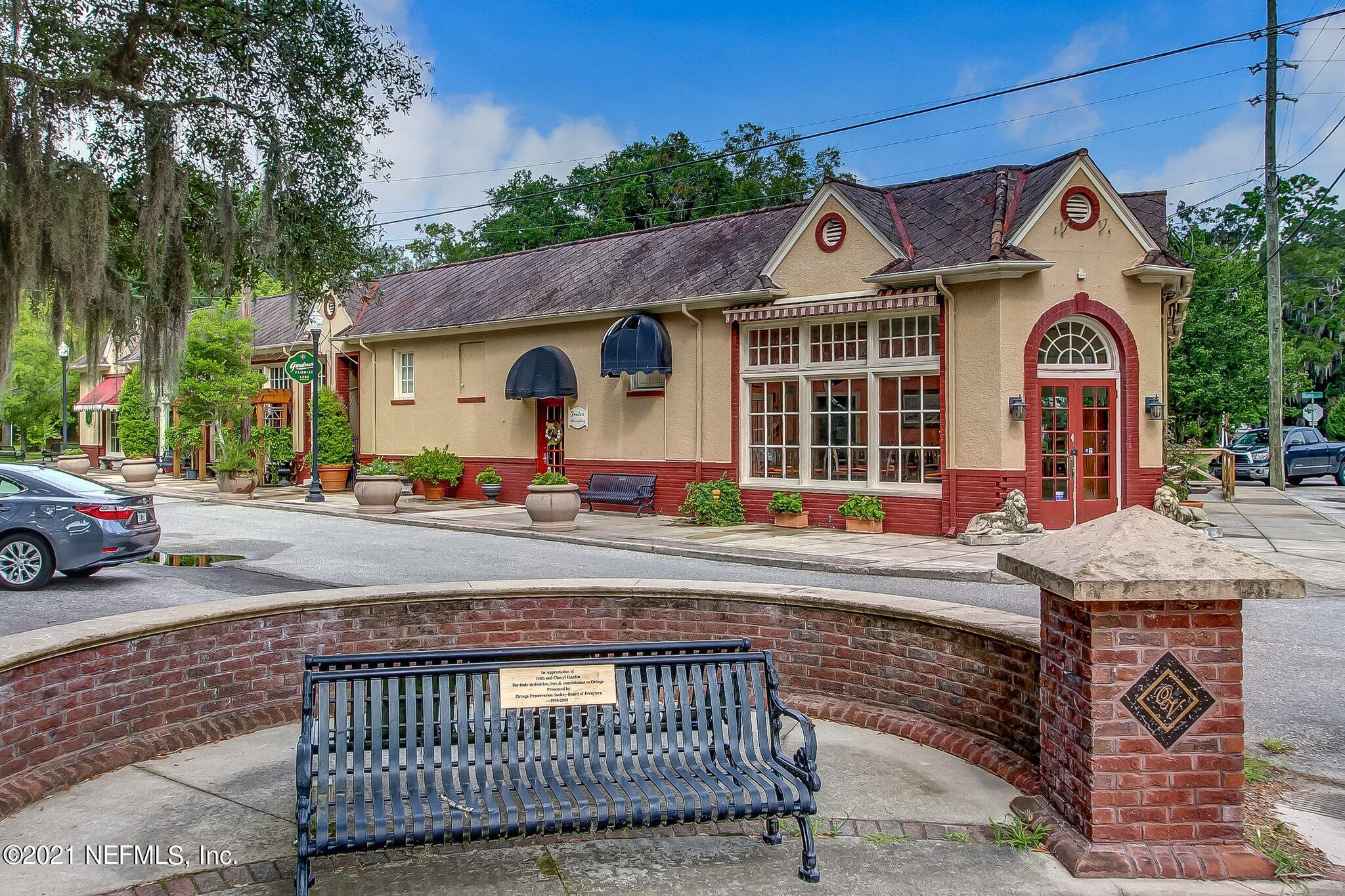 3955 Ortega Boulevard Jacksonville, FL 32210 - Photo 134 of 170 a view of a white house with large windows and a table and chairs