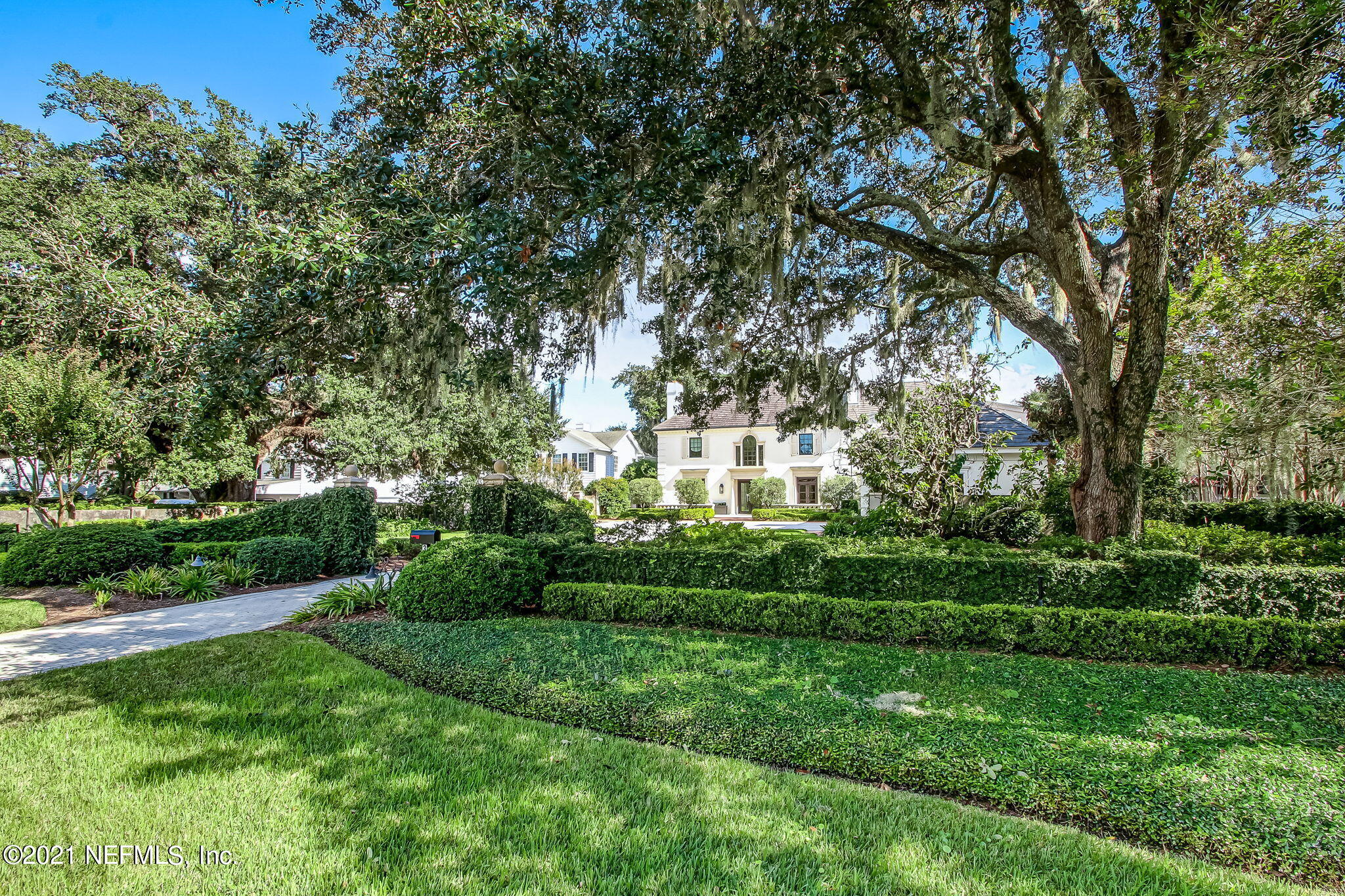 3955 Ortega Boulevard Jacksonville, FL 32210 - Photo 169 of 170 a view of a white house in front of a big yard with plants and large trees