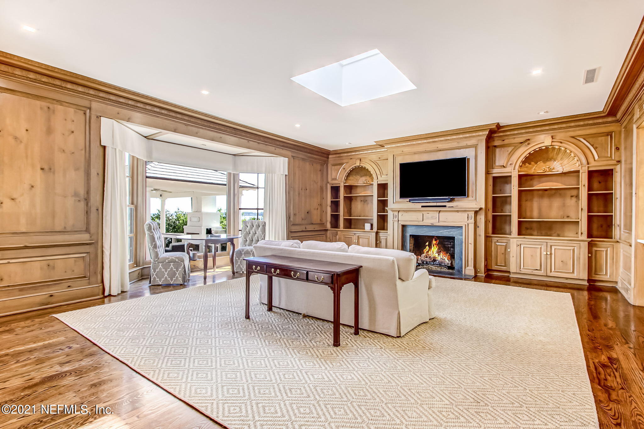 3955 Ortega Boulevard Jacksonville, FL 32210 - Photo 36 of 170 a living room with furniture a fireplace and a flat screen tv