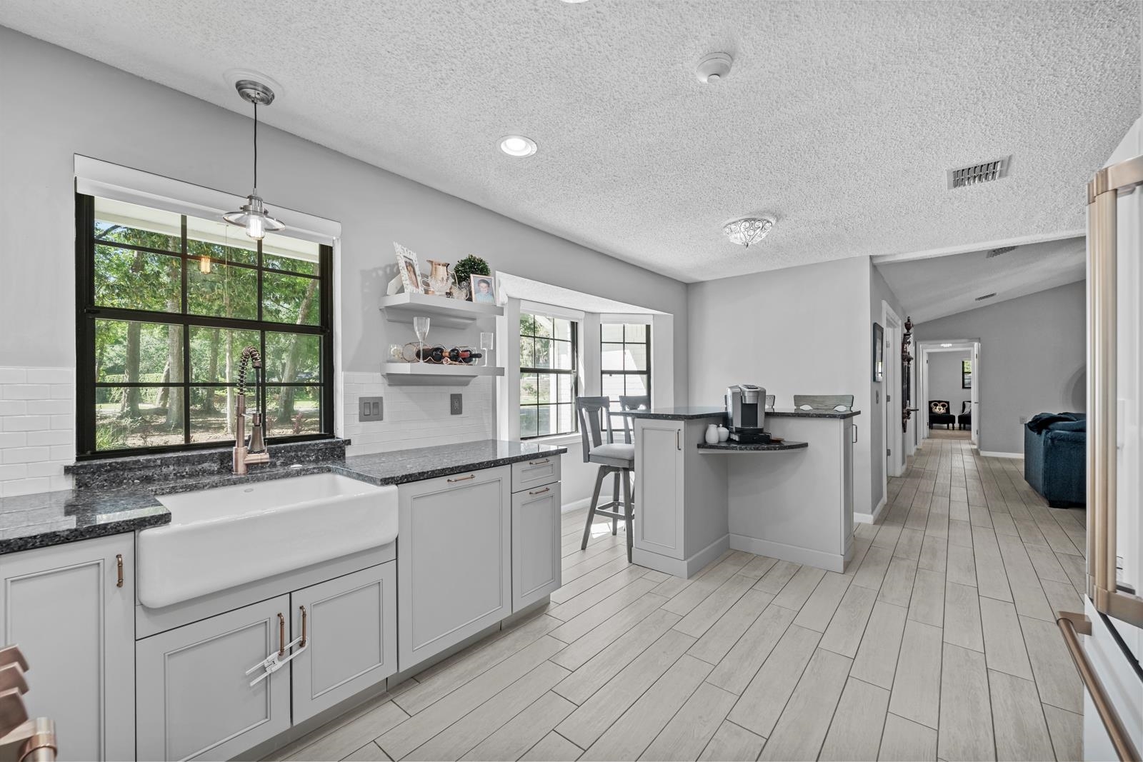 3911 Hillwood Road Jacksonville, FL 32223 - Photo 10 of 33 Kitchen with decorative light fixtures, a textured ceiling, tasteful backsplash, and vaulted ceiling
