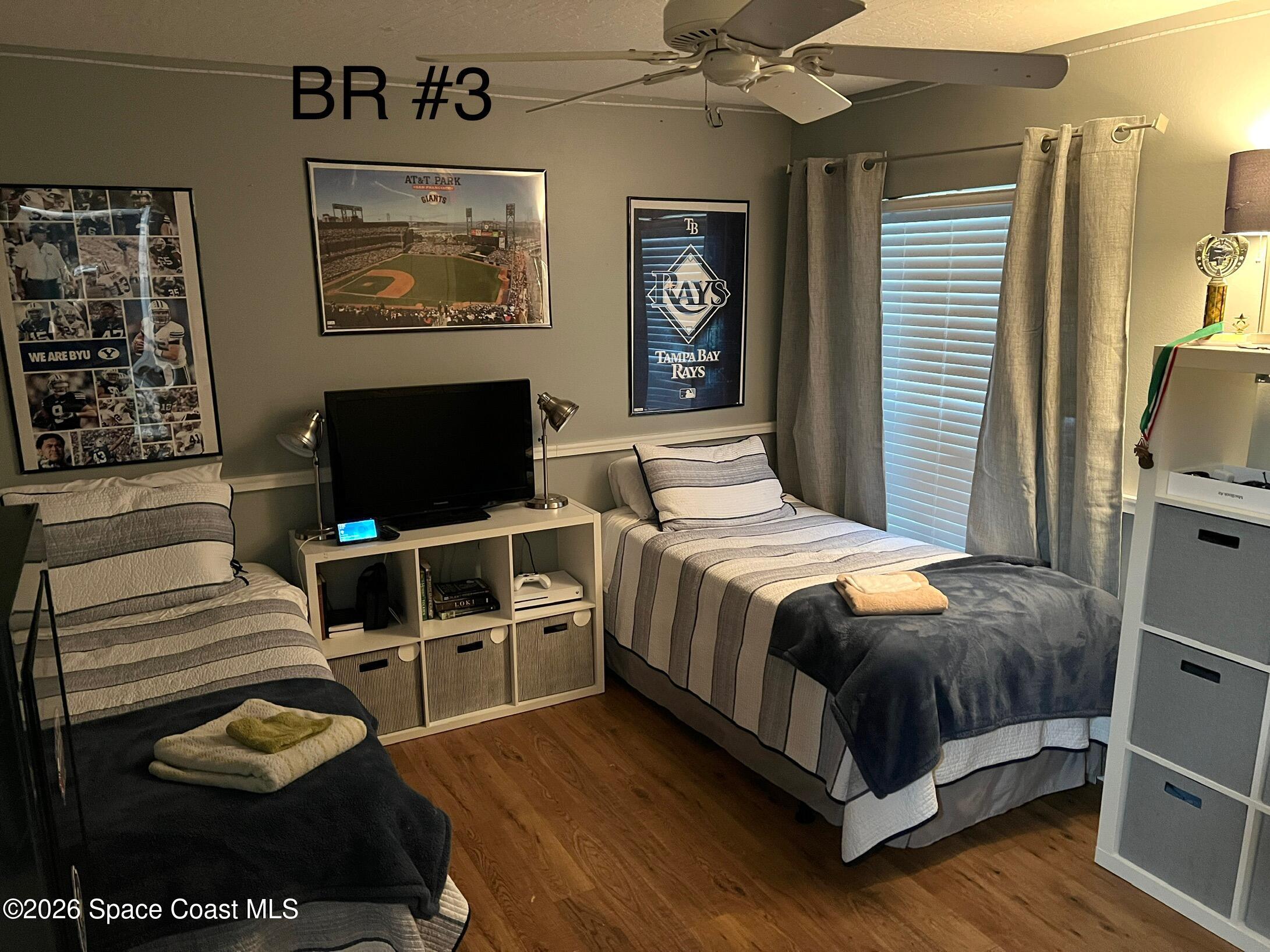 4130 Orion Way Rockledge, FL 32955 - Photo 3 of 14 a bedroom with a bed and wooden floor