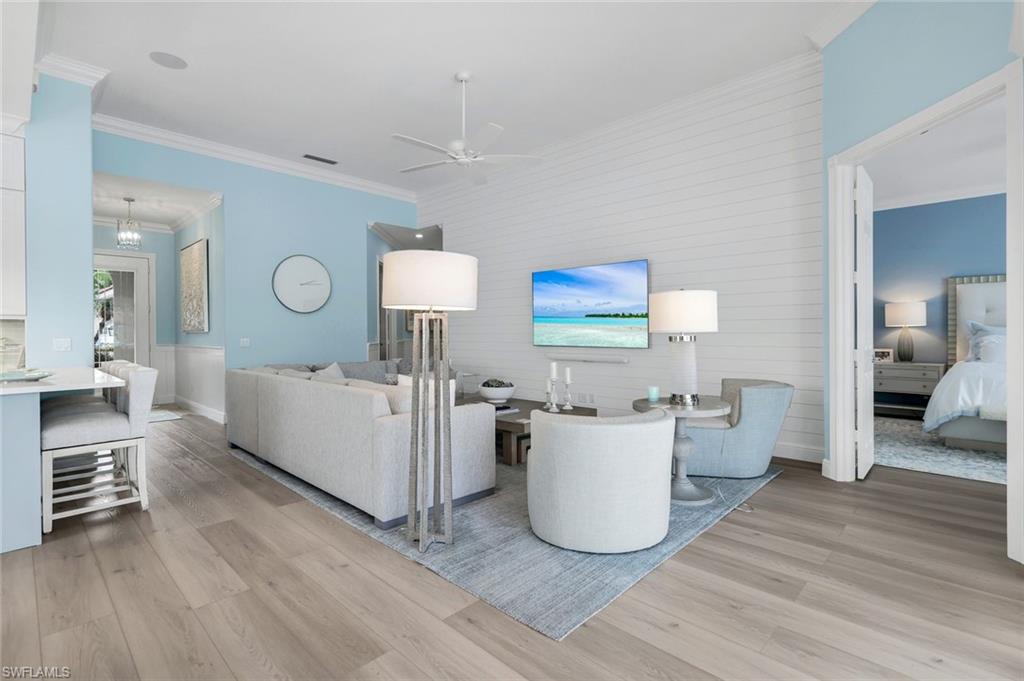 3787 Whidbey Way Naples, FL 34119 - Photo 13 of 50 a living room with furniture and a wooden floor