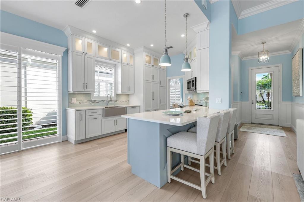 3787 Whidbey Way Naples, FL 34119 - Photo 15 of 50 a large kitchen with a table and chairs in it