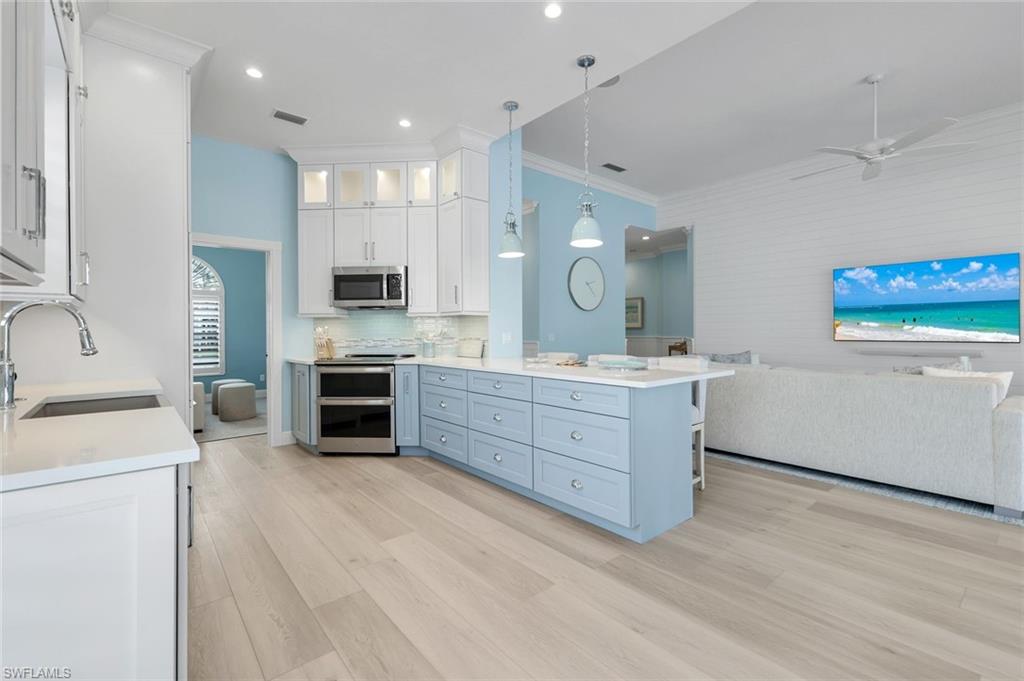 3787 Whidbey Way Naples, FL 34119 - Photo 50 of 50 a large bathroom with a double vanity sink a large mirror and a