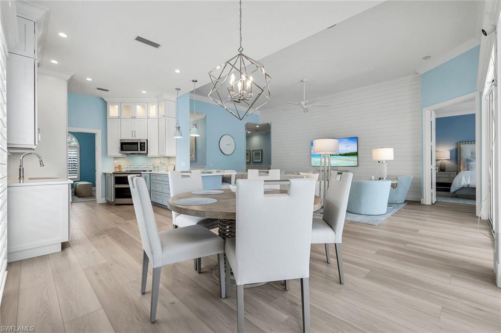 3787 Whidbey Way Naples, FL 34119 - Photo 17 of 50 a view of a dining room with furniture and wooden floor