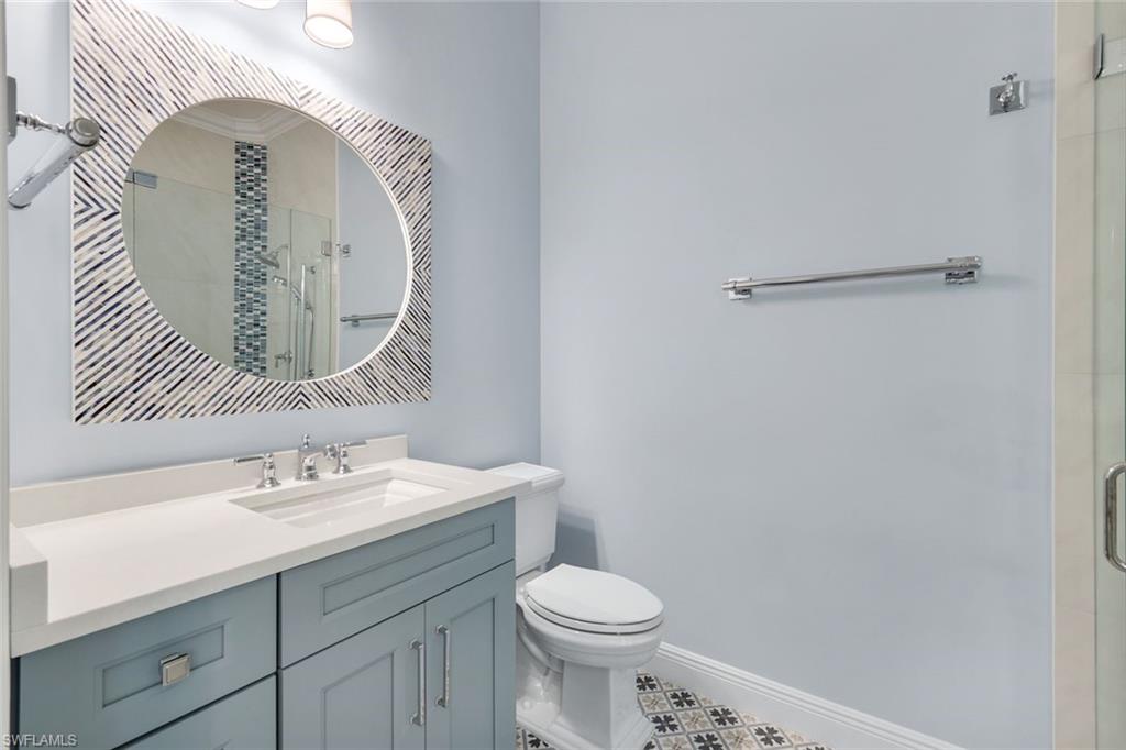 3787 Whidbey Way Naples, FL 34119 - Photo 21 of 50 a bathroom with a sink mirror vanity and toilet