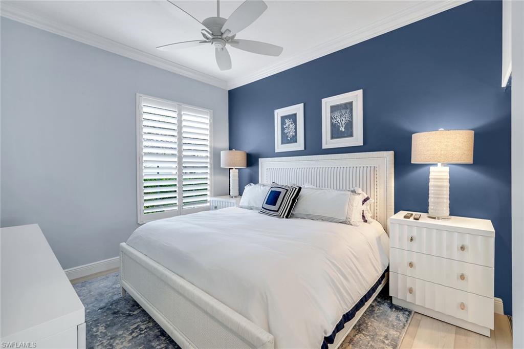 3787 Whidbey Way Naples, FL 34119 - Photo 23 of 50 a bedroom with a bed and a chandelier