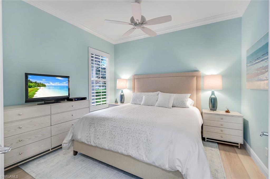 3787 Whidbey Way Naples, FL 34119 - Photo 25 of 50 a bedroom with a bed and a flat screen tv