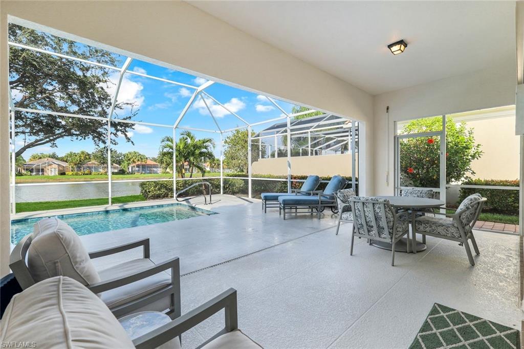 3787 Whidbey Way Naples, FL 34119 - Photo 27 of 50 a view of a patio with couches and table and chairs with wooden floor and fence