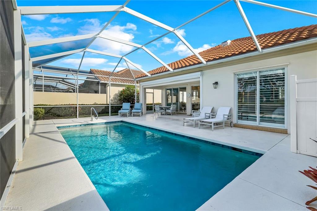 3787 Whidbey Way Naples, FL 34119 - Photo 31 of 50 a swimming pool with outdoor seating and yard
