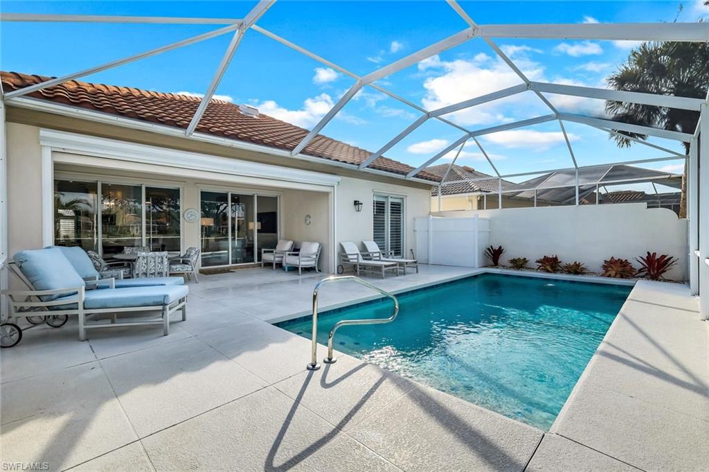 3787 Whidbey Way Naples, FL 34119 - Photo 32 of 50 a view of a patio with table and chairs potted plants with wooden floor
