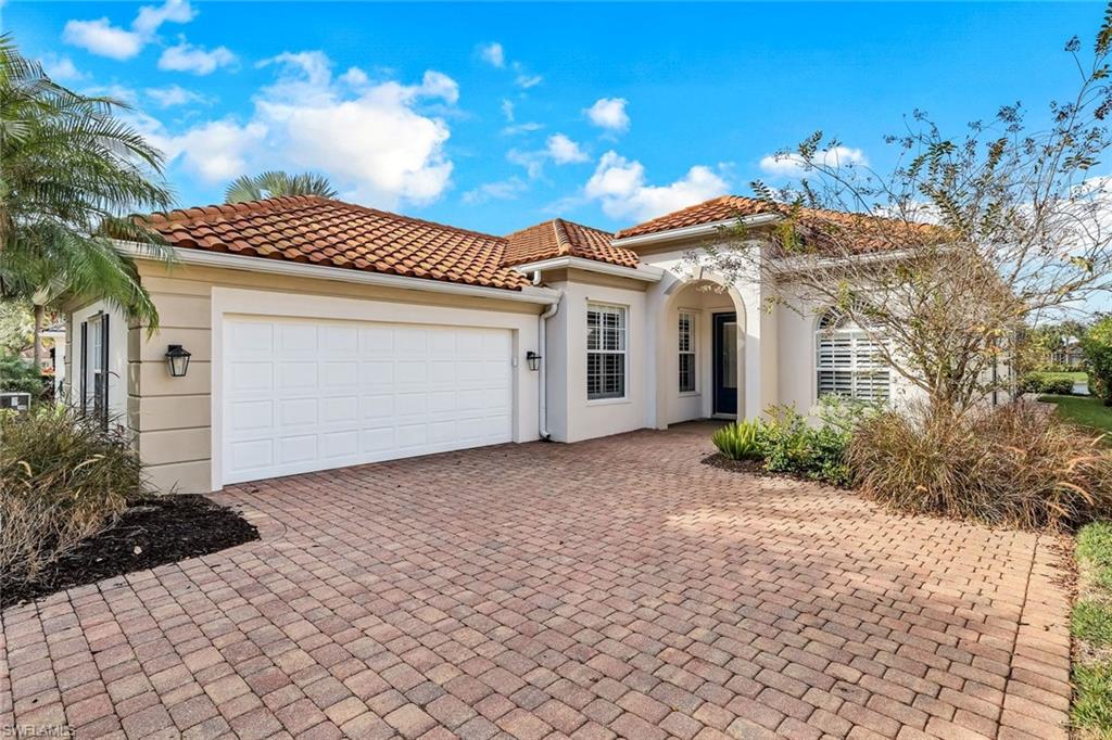 3787 Whidbey Way Naples, FL 34119 - Photo 7 of 50 a front view of a house with a yard