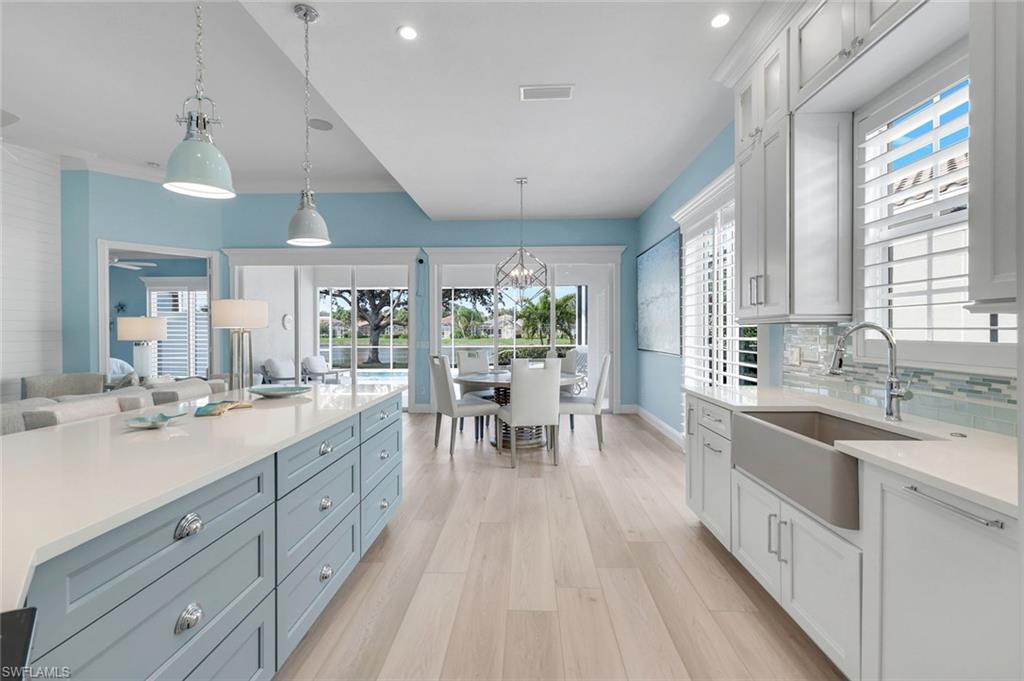 3787 Whidbey Way Naples, FL 34119 - Photo 49 of 50 a large kitchen with stainless steel appliances a lot of counter space and a wooden floors