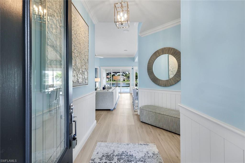 3787 Whidbey Way Naples, FL 34119 - Photo 8 of 50 a living room with furniture and a mirror