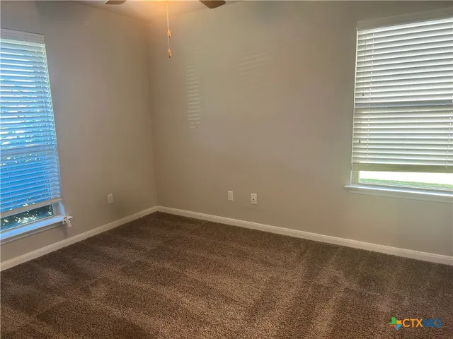 an empty room with a empty space and a window