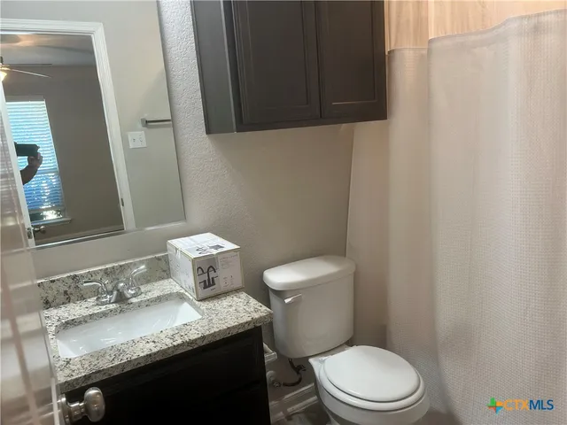 a white toilet sitting next to a bathroom sink