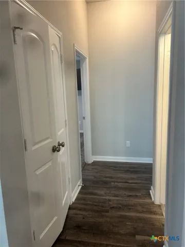 a view of a bathroom with wooden floor and a window