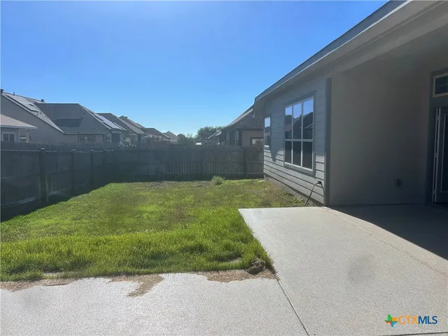 a view of backyard with potted plants