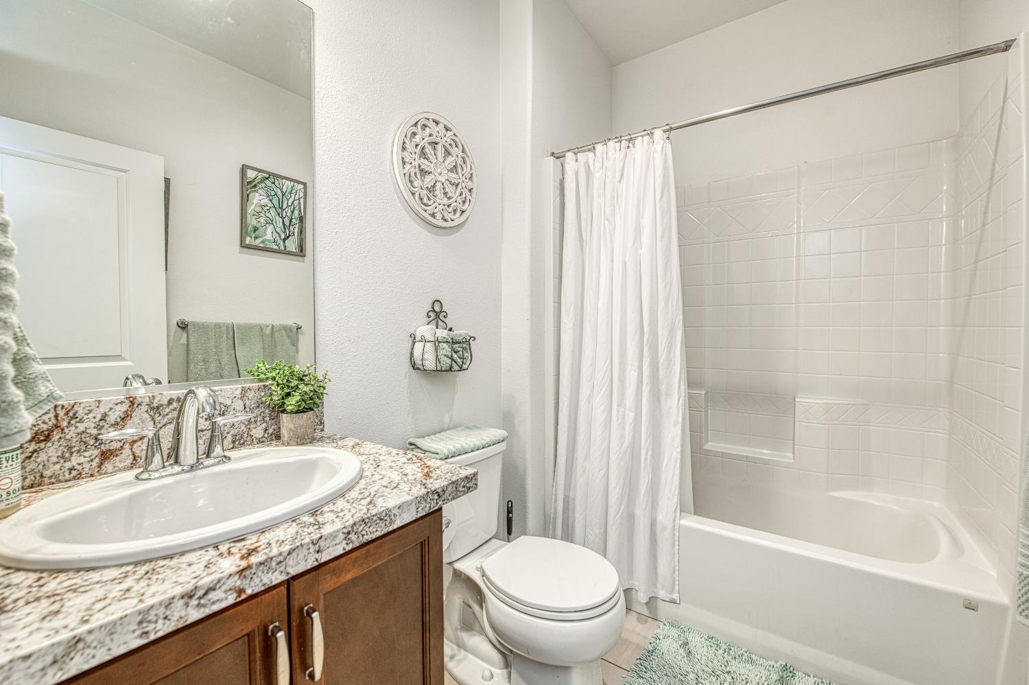 4534 Hillside Road Madera, CA 93636 - Photo 16 of 92 a bathroom with a granite countertop sink toilet and shower