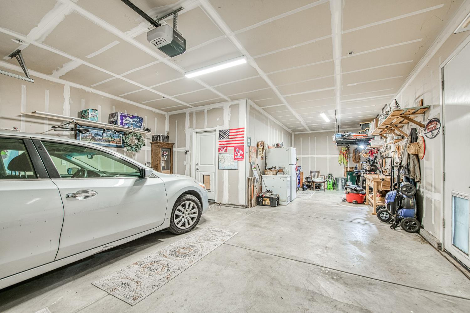 4534 Hillside Road Madera, CA 93636 - Photo 25 of 92 a view of parking garage with cars and a garage