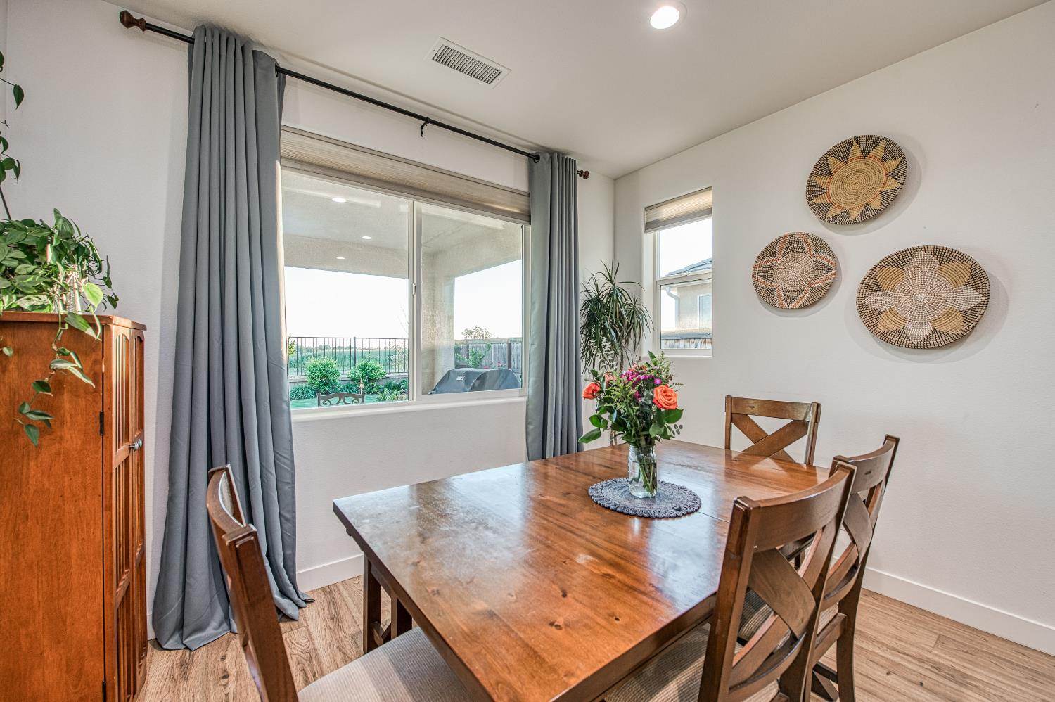 4534 Hillside Road Madera, CA 93636 - Photo 39 of 92 a view of a dining room with furniture clock and a large window
