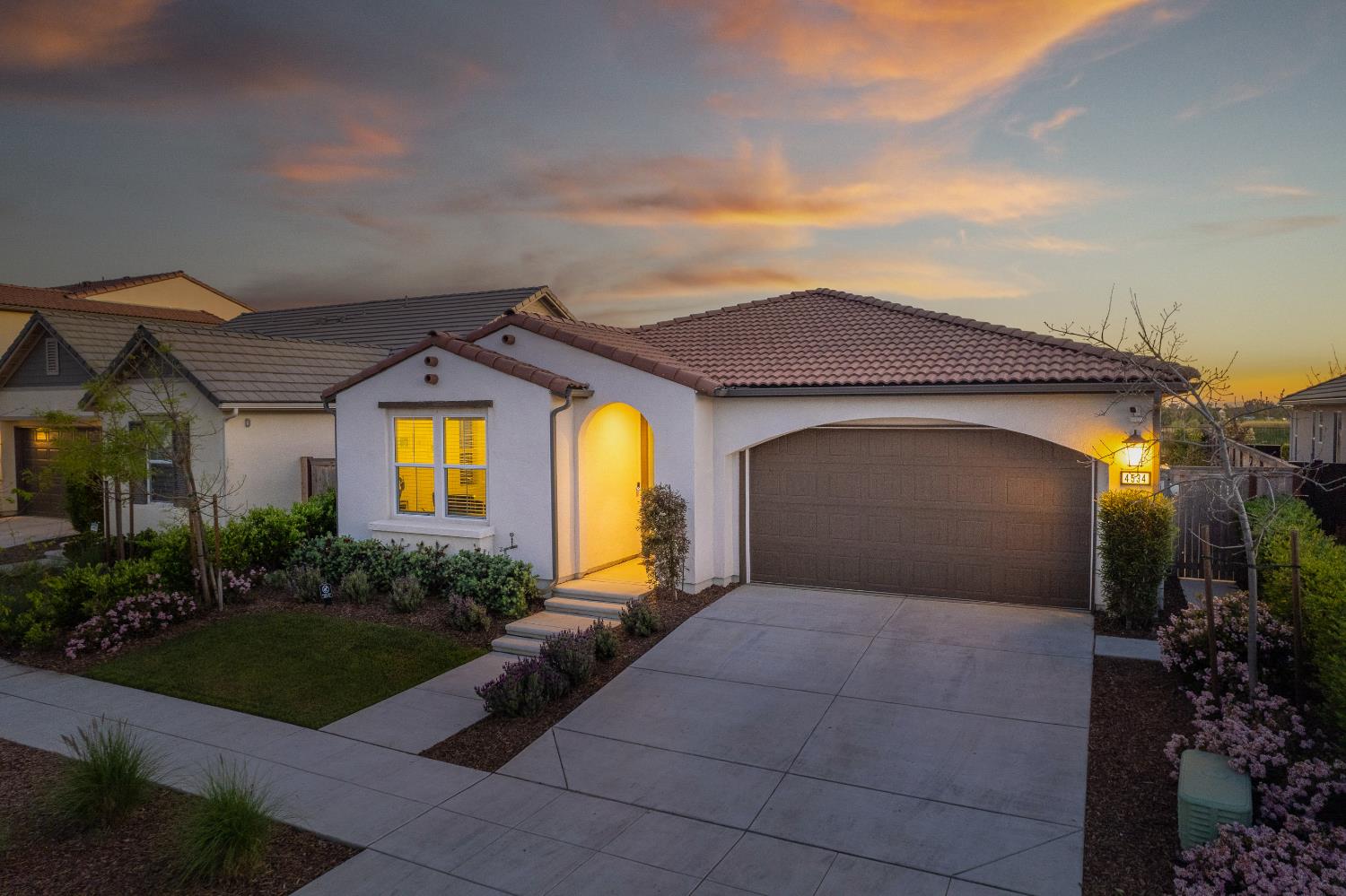 4534 Hillside Road Madera, CA 93636 - Photo 72 of 92 a front view of a house with a yard and garage