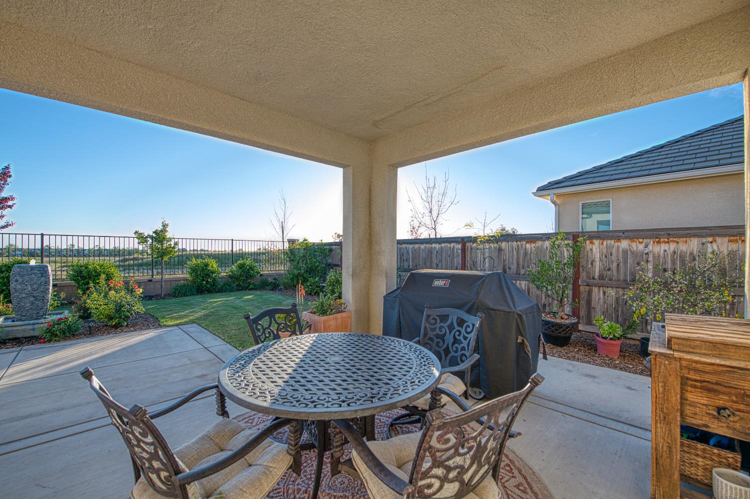 4534 Hillside Road Madera, CA 93636 - Photo 84 of 92 a view of a patio with table and chairs with wooden floor and fence