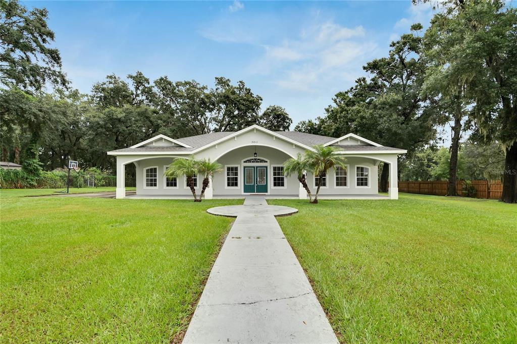 a front view of house with yard and green space