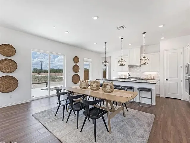 a dining room with furniture and wooden floor