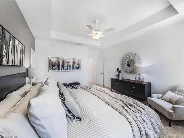 a bedroom with a bed and a chandelier