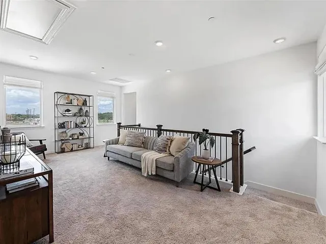 a living room with furniture and a book shelf