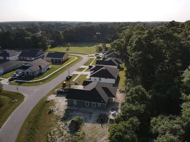 an aerial view of a house with a yard