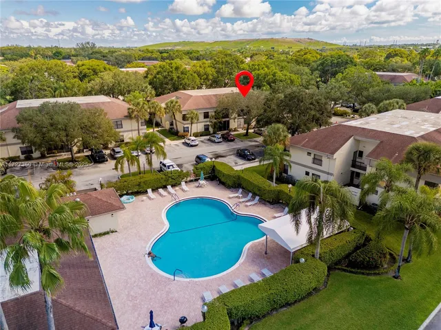 a view of a swimming pool and outdoor seating