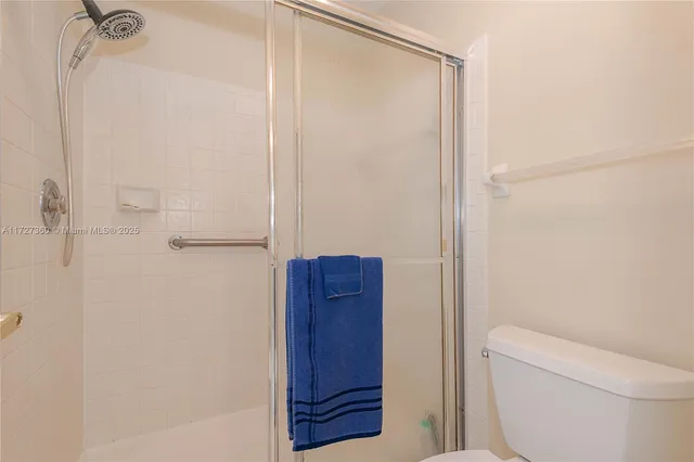 a bathroom with a shower and a toilet