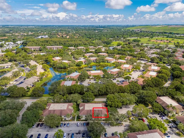 an aerial view of residential houses with outdoor space and street view