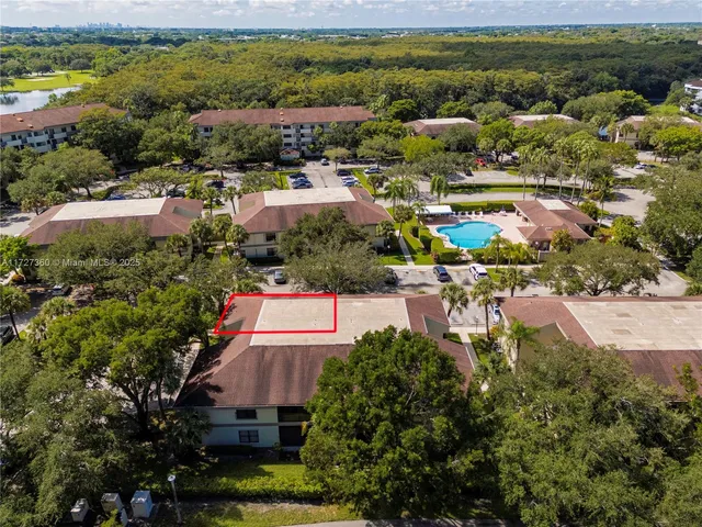 a view of a city with lots of residential buildings ocean and mountain view in back